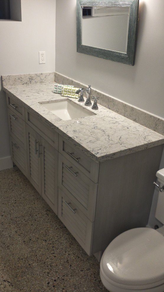 Inspiration for a beach style bathroom in Other with louvered cabinets, grey cabinets, terrazzo floors, engineered quartz benchtops and grey floor.