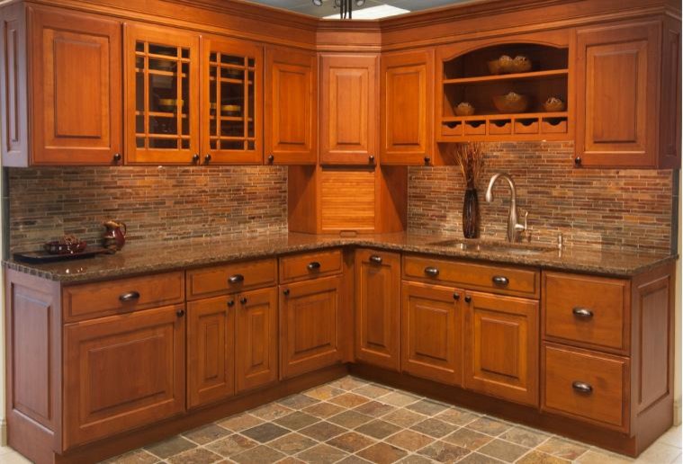 This is an example of a mid-sized traditional l-shaped eat-in kitchen in Providence with an undermount sink, raised-panel cabinets, medium wood cabinets, granite benchtops, multi-coloured splashback and no island.
