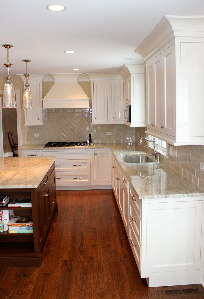 Example of a transitional u-shaped dark wood floor eat-in kitchen design in Chicago with a double-bowl sink, raised-panel cabinets, beige cabinets, granite countertops, beige backsplash, ceramic backsplash, stainless steel appliances and beige walls