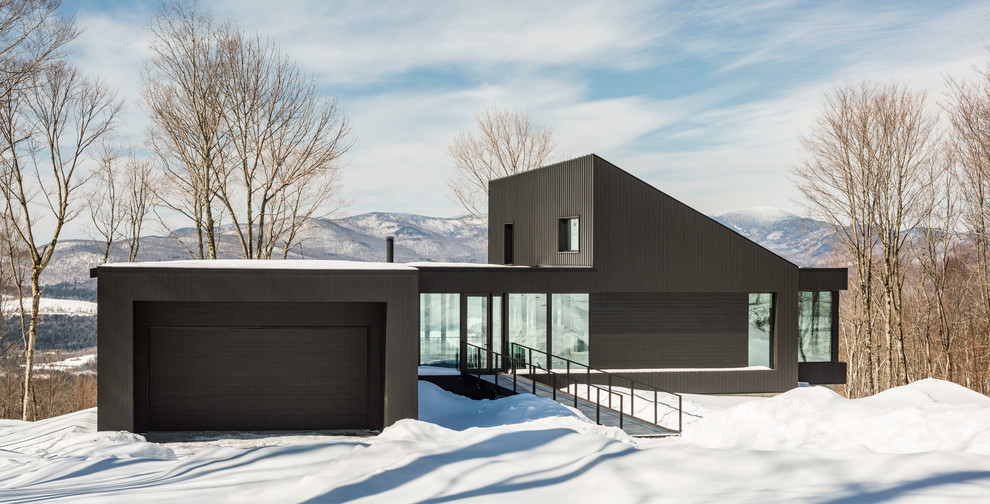 Inspiration for a contemporary two-storey grey house exterior in Burlington with metal siding and a flat roof.