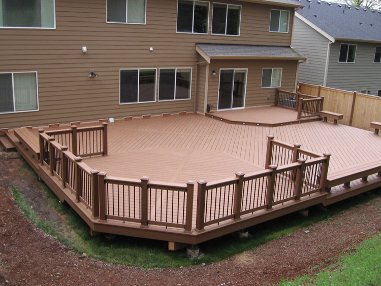 Mid-sized traditional backyard patio in Seattle with decking and a roof extension.