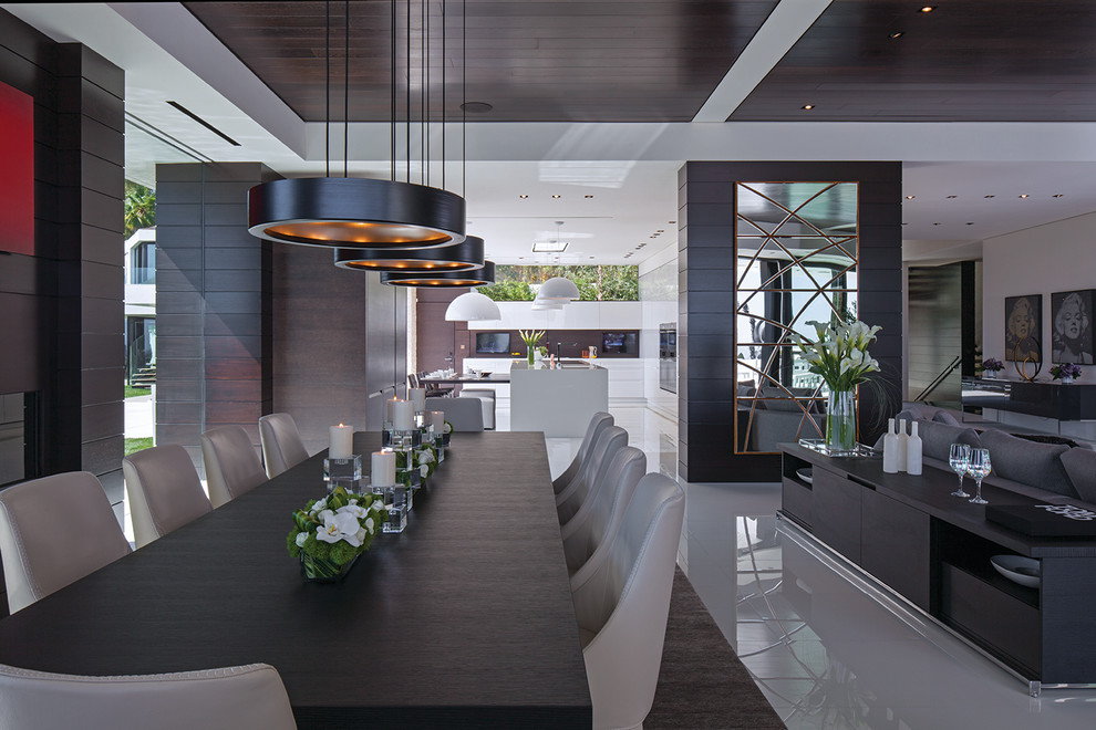 Photo of an expansive modern open plan dining in Los Angeles with white floor and recessed.
