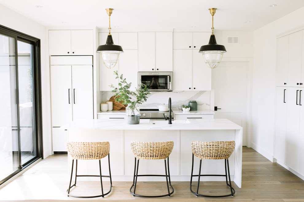 Inspiration for a transitional l-shaped medium tone wood floor and brown floor kitchen remodel with flat-panel cabinets, paneled appliances and an island