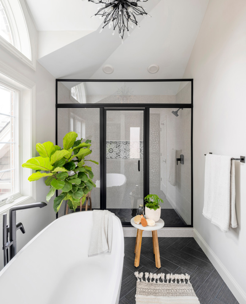 Design ideas for a modern bathroom in Minneapolis with light wood cabinets, a claw-foot tub, an alcove shower, beige walls, a trough sink, grey floor, a hinged shower door, beige benchtops, a shower seat, a double vanity and vaulted.
