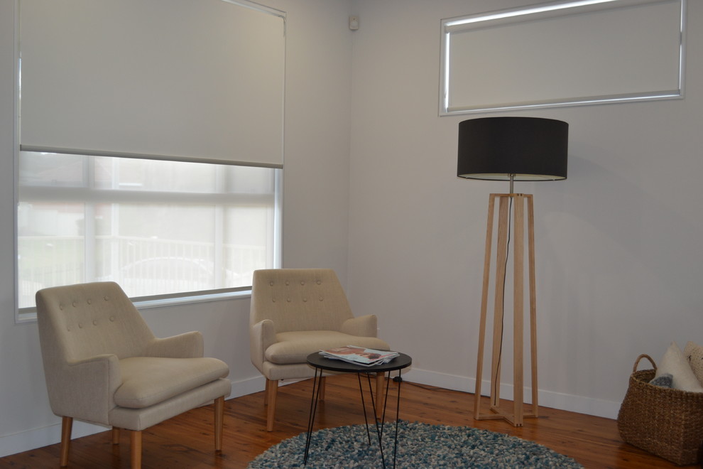 This is an example of a mid-sized scandinavian open concept living room in Sydney with beige walls and light hardwood floors.