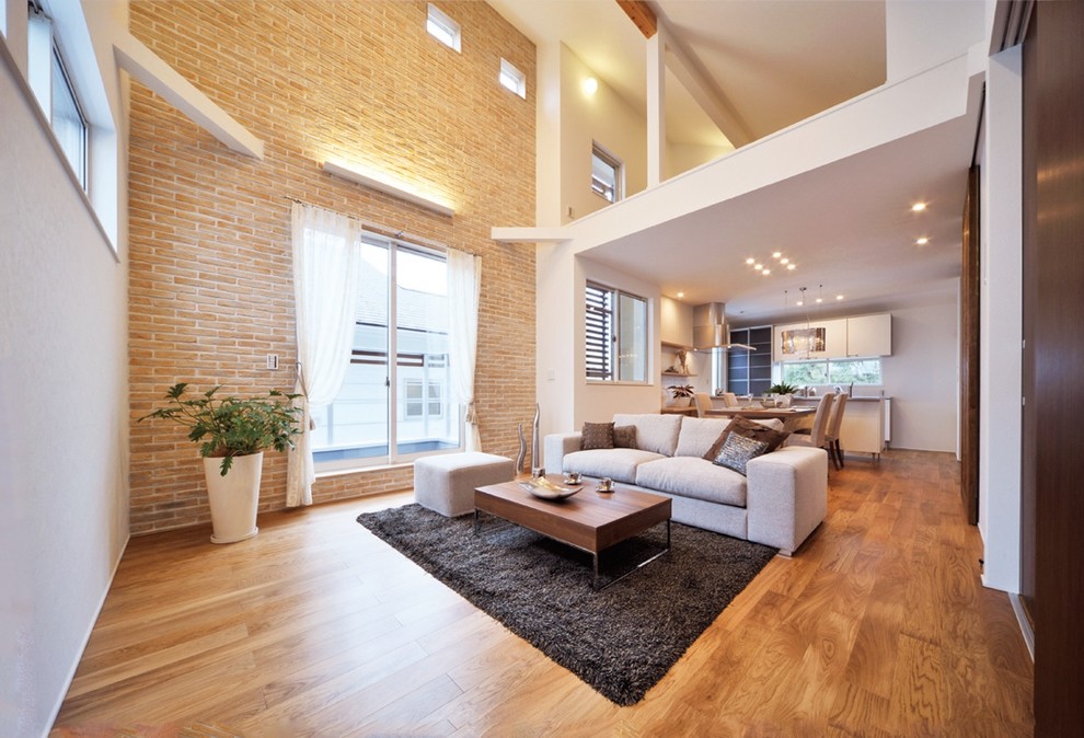 This is an example of an asian living room in Nagoya with white walls, medium hardwood floors and brown floor.