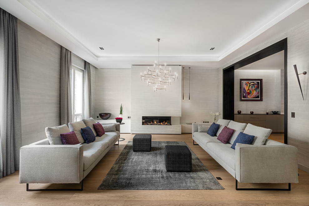 This is an example of a large contemporary formal enclosed living room in Paris with no tv, grey walls, medium hardwood floors, a ribbon fireplace and brown floor.