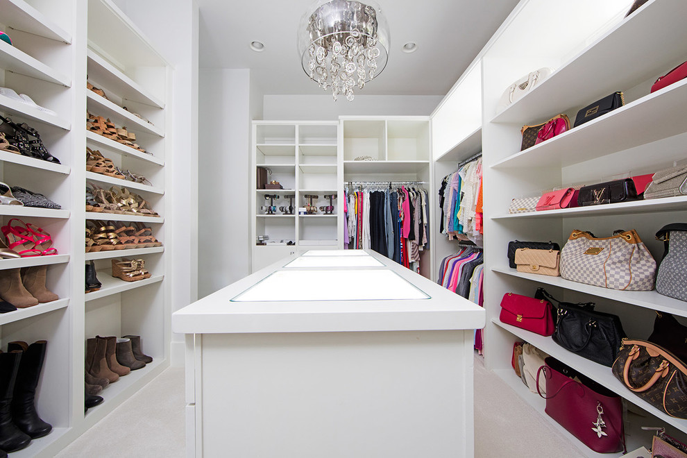 Inspiration for a transitional women's walk-in wardrobe in Indianapolis with open cabinets, white cabinets, carpet and beige floor.