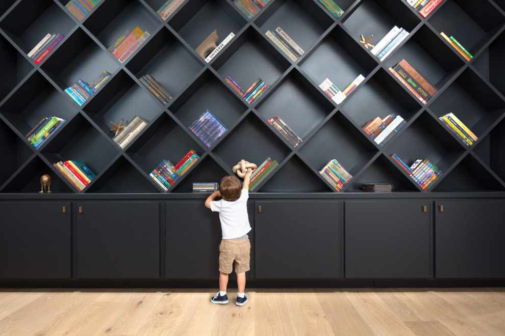 Kids' Bookshelf Reading Room Built-Ins - This striking black built-in bookshelf is unique in that it's cubbies are diamond shaped, giving the built-in bookshelf wall an edge.