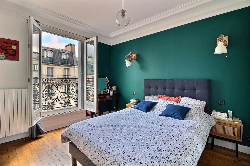 Example of a large trendy master dark wood floor and brown floor bedroom design in Paris with green walls