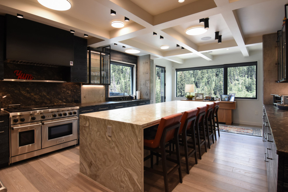 Minimalist u-shaped light wood floor and coffered ceiling eat-in kitchen photo in Salt Lake City with a drop-in sink, flat-panel cabinets, black cabinets, marble countertops, multicolored backsplash, marble backsplash, stainless steel appliances, an island and multicolored countertops