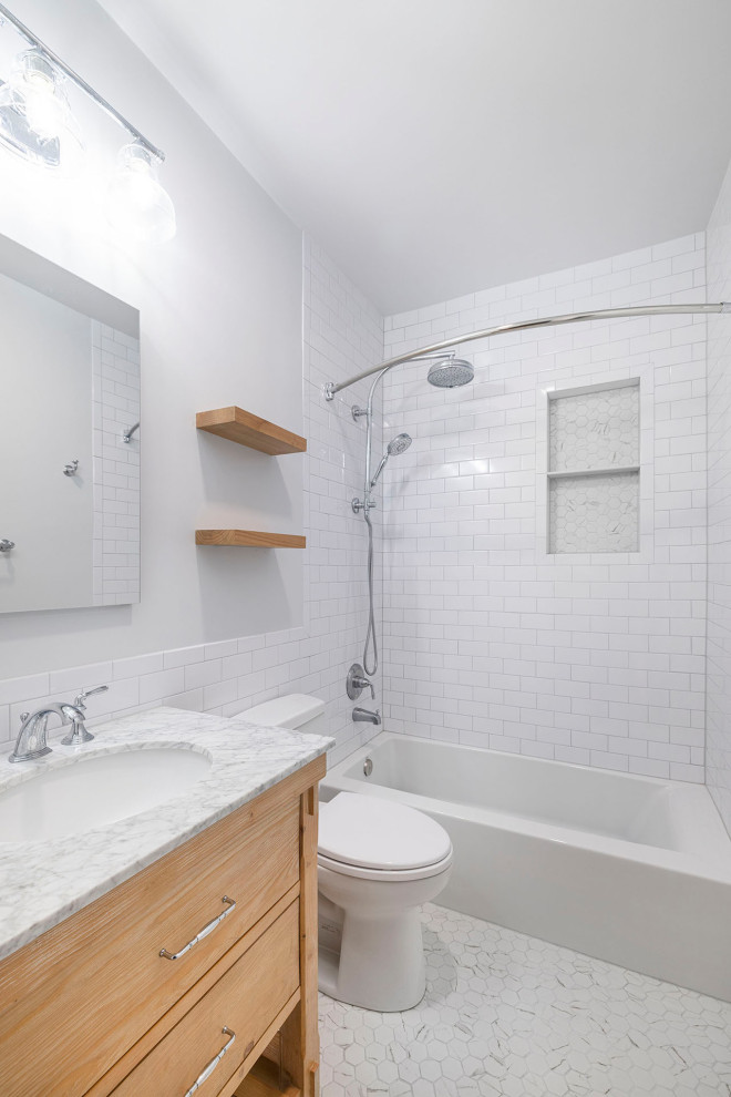 Medium sized farmhouse ensuite bathroom in DC Metro with medium wood cabinets, an alcove bath, a two-piece toilet, white tiles, ceramic tiles, grey walls, mosaic tile flooring, a submerged sink, marble worktops, white floors, grey worktops, a wall niche, a single sink, a freestanding vanity unit and freestanding cabinets.