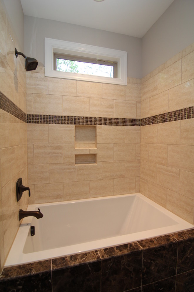 Photo of a mid-sized traditional bathroom in Raleigh with an undermount sink, recessed-panel cabinets, dark wood cabinets, an alcove tub, an alcove shower, a one-piece toilet, brown tile, ceramic tile, grey walls and ceramic floors.