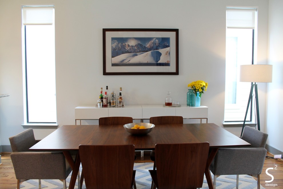 Inspiration for a mid-sized midcentury open plan dining in Houston with medium hardwood floors and white walls.