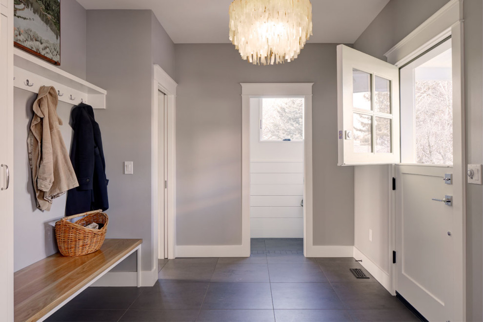 Photo of a country entryway in Seattle with grey walls, ceramic floors, a dutch front door, a white front door and black floor.