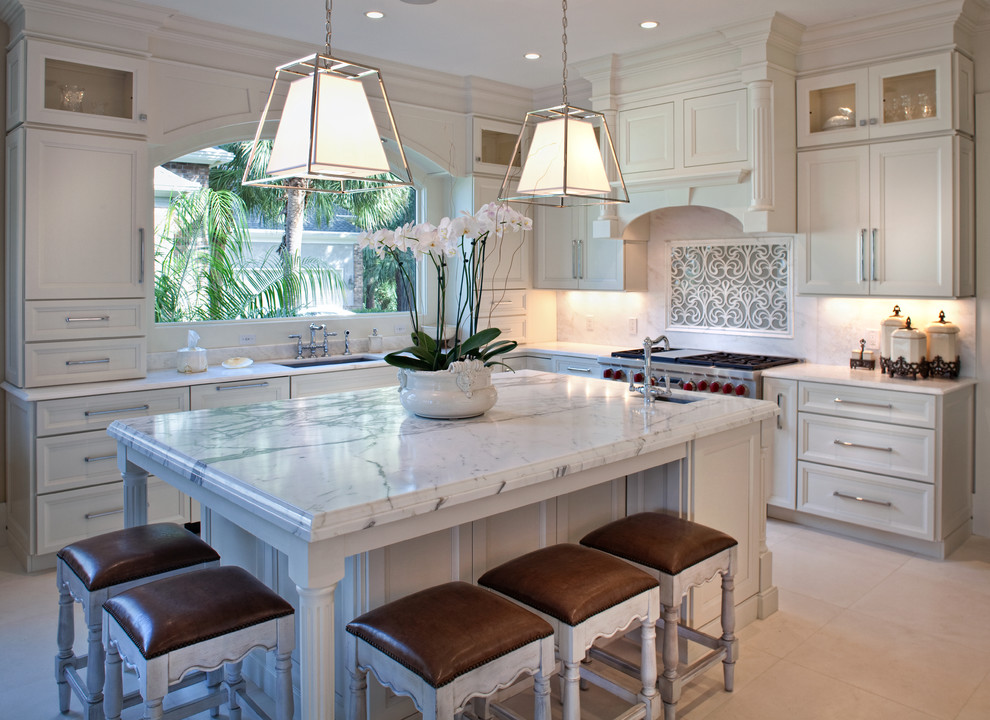 This is an example of a mid-sized traditional l-shaped kitchen in Charleston with an undermount sink, recessed-panel cabinets, white cabinets, white splashback, stainless steel appliances, with island and ceramic floors.