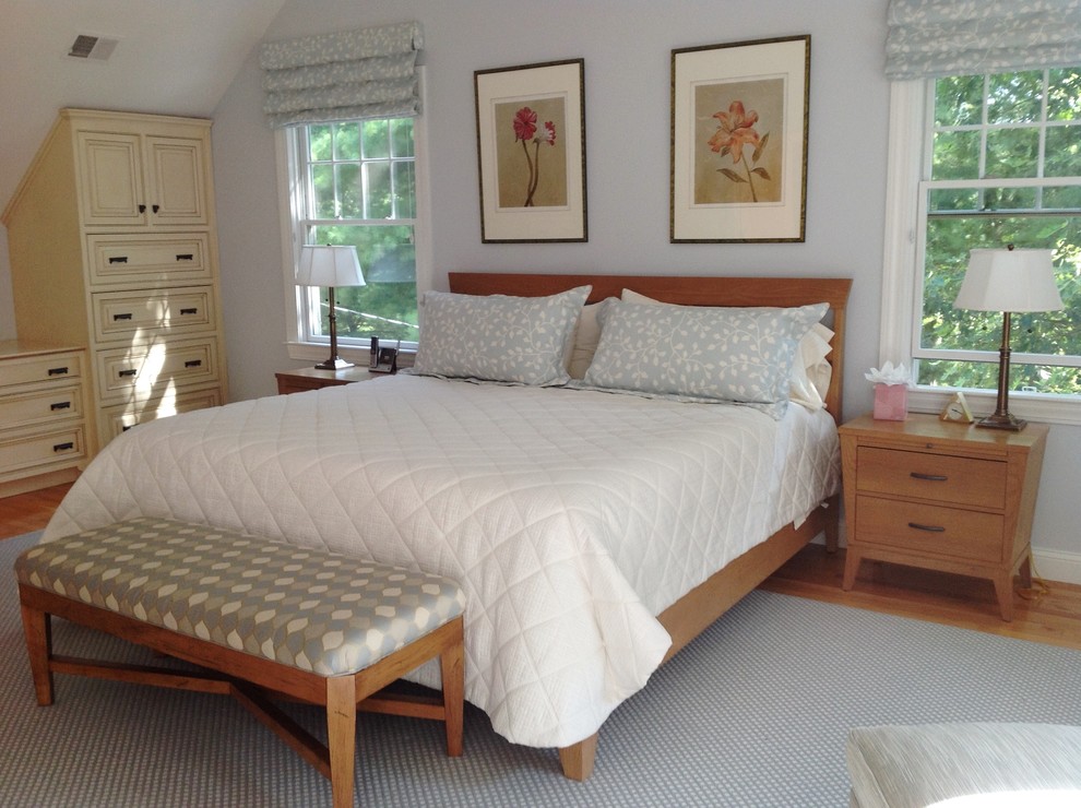 Photo of a large transitional master bedroom in Boston with blue walls, medium hardwood floors and no fireplace.