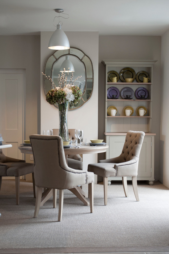 Photo of a transitional dining room in London with grey walls and carpet.