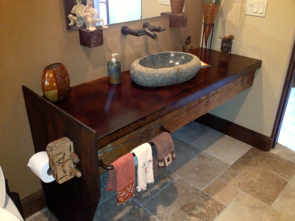 Mid-sized country bathroom in Phoenix with beige walls, travertine floors, a vessel sink, concrete benchtops, brown floor and brown benchtops.