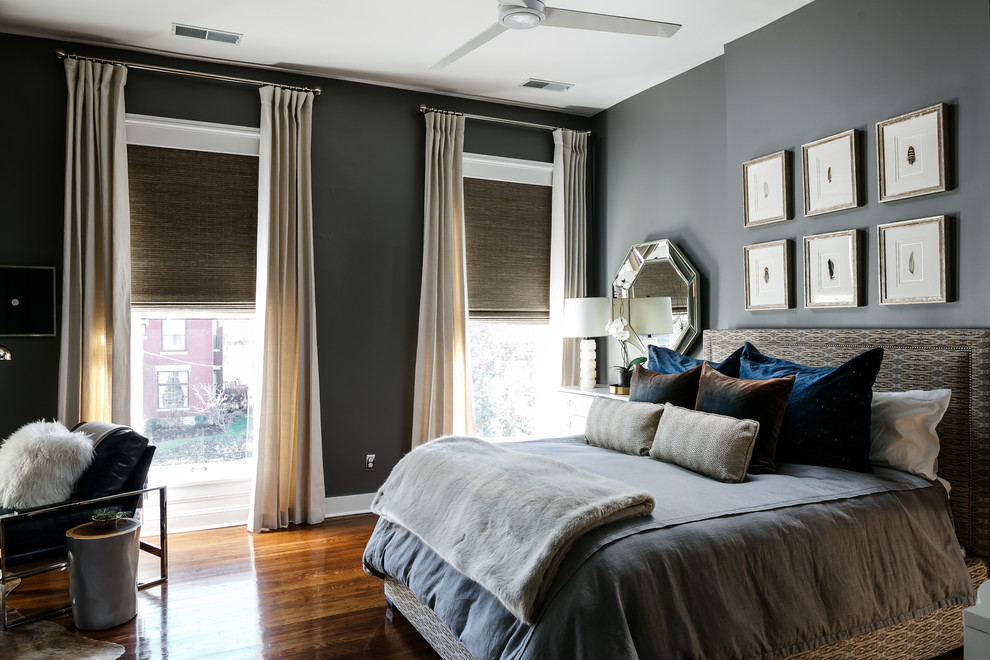 Inspiration for a mid-sized modern master bedroom in Louisville with grey walls, medium hardwood floors, a standard fireplace, a wood fireplace surround and brown floor.