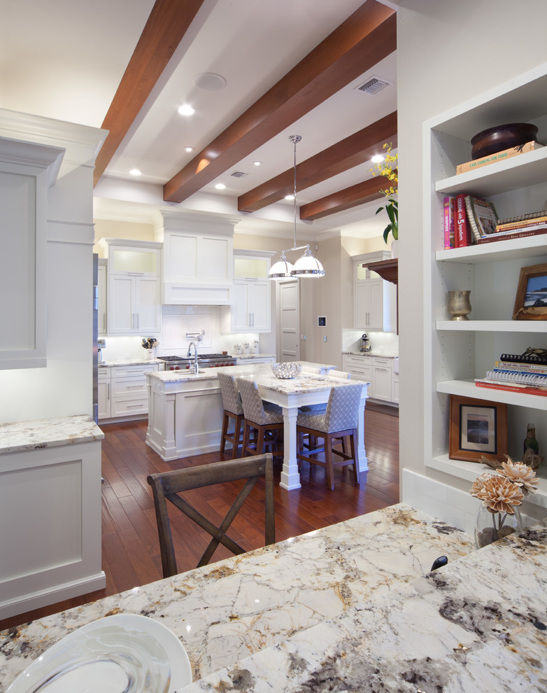 Large eclectic galley eat-in kitchen in Orlando with a drop-in sink, beaded inset cabinets, dark wood cabinets, granite benchtops, white splashback, stainless steel appliances, dark hardwood floors and with island.