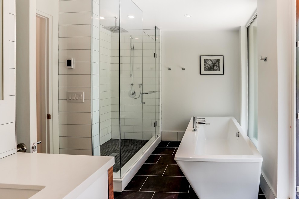 Inspiration for a mid-sized modern 3/4 bathroom in Toronto with flat-panel cabinets, medium wood cabinets, a freestanding tub, an alcove shower, gray tile, ceramic tile, white walls, slate floors, an undermount sink and engineered quartz benchtops.