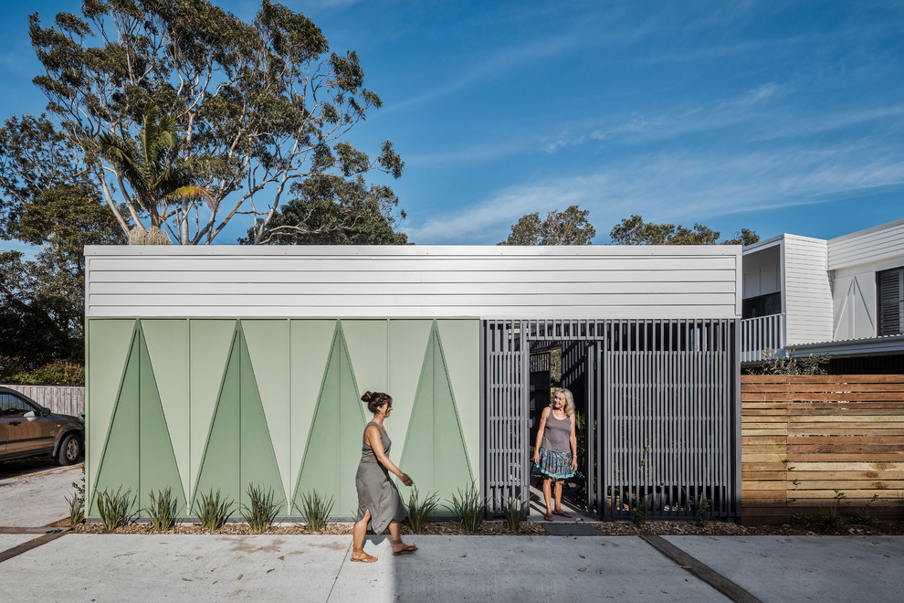 Inspiration for a beach style front door in Gold Coast - Tweed with green walls, concrete floors, a single front door, a gray front door and grey floor.