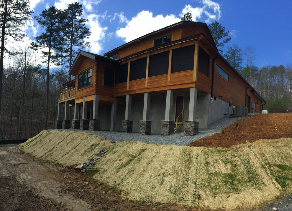 Inspiration for a large rustic multicolored three-story wood gable roof remodel with a shingle roof