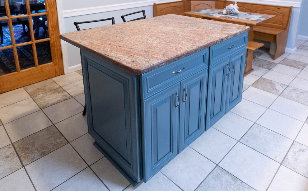 Inspiration for a mid-sized transitional l-shaped separate kitchen in Baltimore with an undermount sink, recessed-panel cabinets, blue cabinets, granite benchtops, beige splashback, stone tile splashback, stainless steel appliances, ceramic floors, with island, beige floor and orange benchtop.