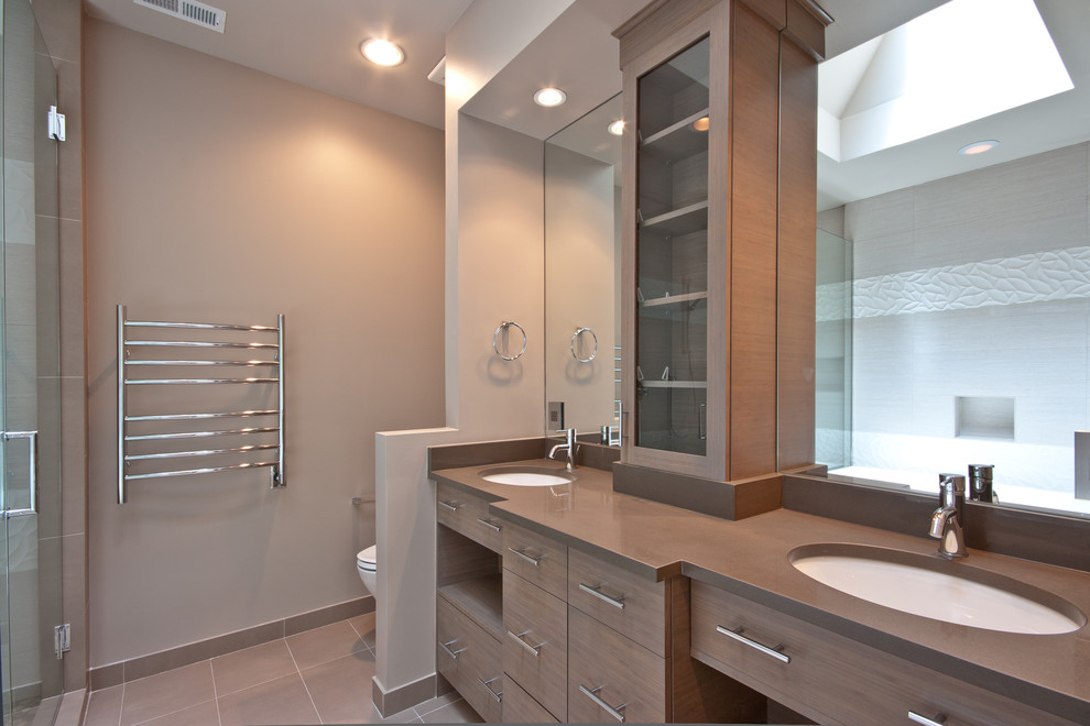 Photo of a contemporary master bathroom in Chicago with medium wood cabinets, a corner shower, a one-piece toilet, beige walls, ceramic floors and a drop-in sink.