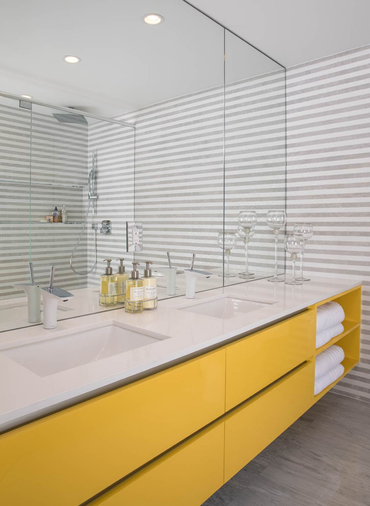 Design ideas for a mid-sized contemporary kids bathroom in Miami with flat-panel cabinets, multi-coloured tile, ceramic tile, marble floors, engineered quartz benchtops, white benchtops, a double vanity, a floating vanity, yellow cabinets, an undermount sink and grey floor.