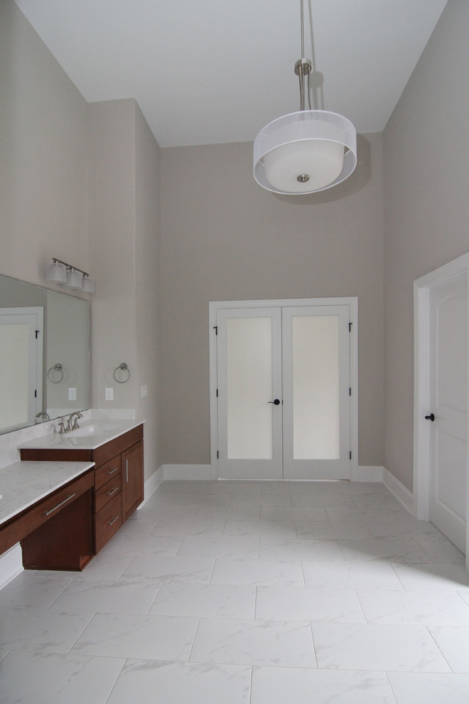 Large contemporary master bathroom in Raleigh with shaker cabinets, medium wood cabinets, an open shower, a one-piece toilet, white tile, ceramic tile, grey walls, ceramic floors, an integrated sink and solid surface benchtops.