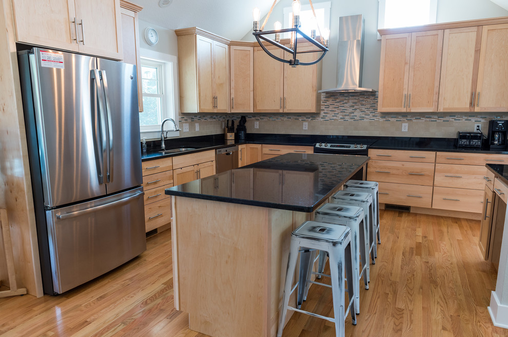 Kitchen - mid-sized transitional l-shaped light wood floor kitchen idea with an undermount sink, shaker cabinets, light wood cabinets, beige backsplash, subway tile backsplash, stainless steel appliances and an island