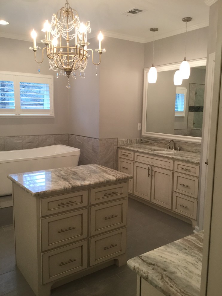 Inspiration for a large modern master bathroom in Other with white cabinets, a freestanding tub, gray tile, porcelain tile, grey walls, ceramic floors, a drop-in sink and granite benchtops.