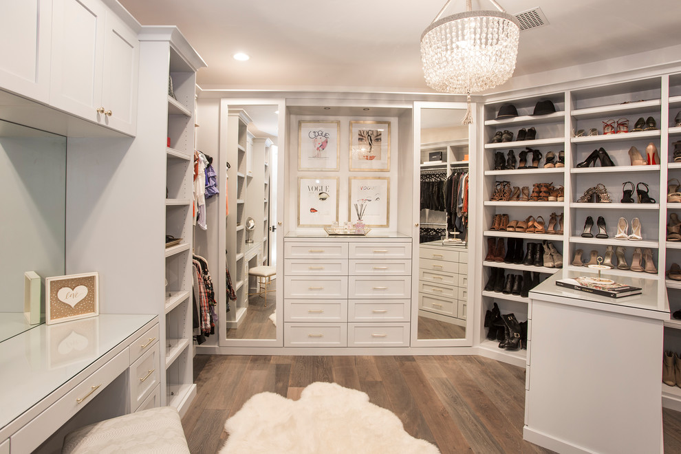 Inspiration for a beach style walk-in wardrobe in Los Angeles with shaker cabinets, white cabinets, medium hardwood floors and brown floor.