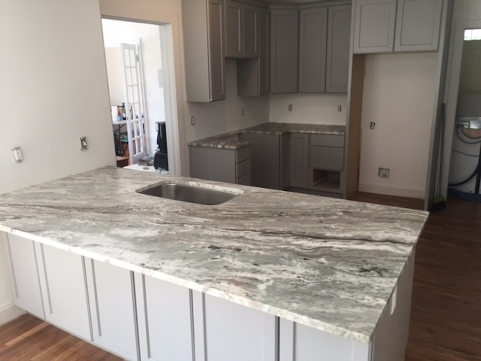 This is an example of a small contemporary u-shaped separate kitchen in Richmond with granite benchtops and no island.