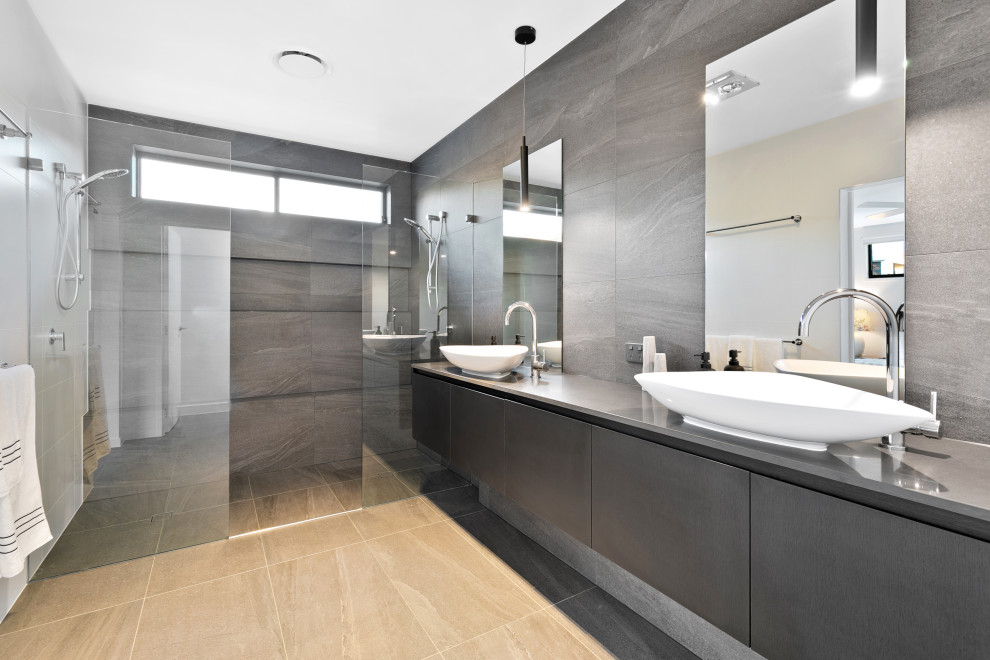 Photo of a mid-sized master bathroom in Brisbane with black cabinets, a double shower, black and white tile, porcelain tile, black walls, porcelain floors, a vessel sink, engineered quartz benchtops, black floor, an open shower, black benchtops, a shower seat, a double vanity and a floating vanity.