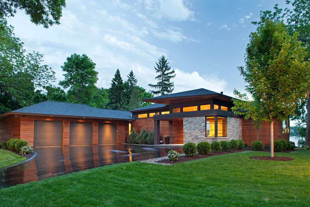 Photo of a contemporary exterior in Minneapolis with wood siding and a hip roof.