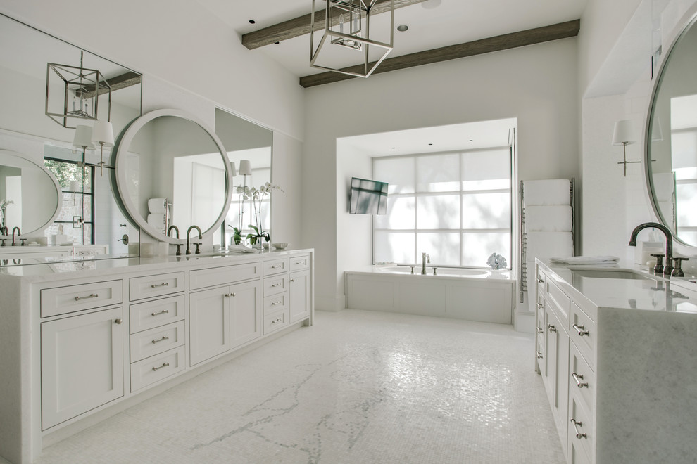 Inspiration for an expansive transitional master bathroom in Dallas with shaker cabinets, white cabinets, a drop-in tub, white tile, white walls, mosaic tile floors, an undermount sink, marble benchtops, mosaic tile and a double shower.
