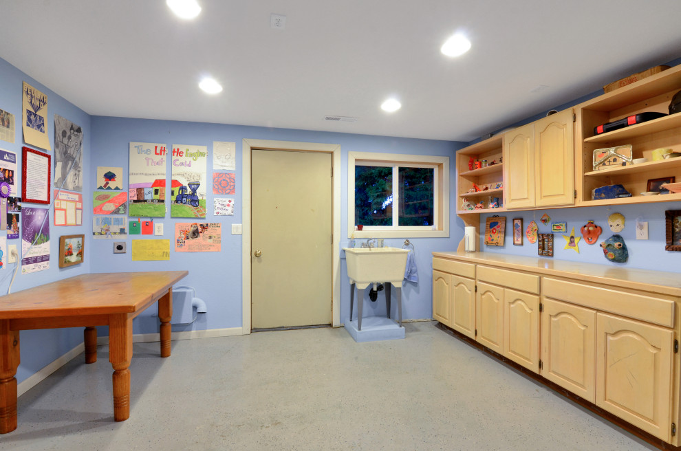 This is an example of a large contemporary craft room in Seattle with a freestanding desk.