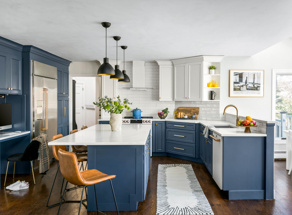Kitchen - mid-sized transitional u-shaped dark wood floor and brown floor kitchen idea in Boston with an undermount sink, recessed-panel cabinets, blue cabinets, white backsplash, subway tile backsplash, stainless steel appliances, an island and white countertops