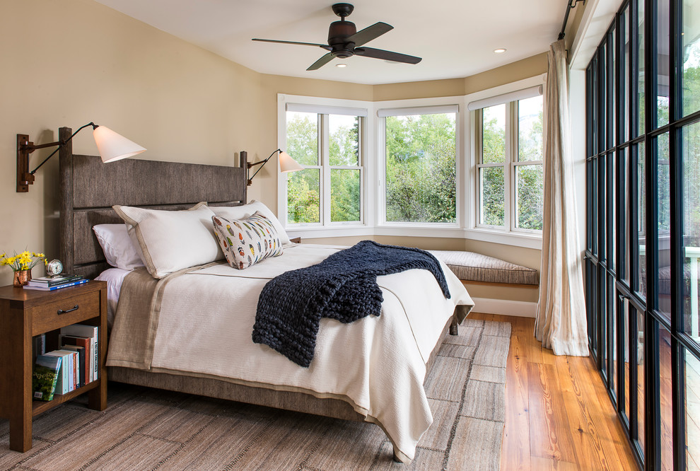 Design ideas for a mid-sized country master bedroom in Other with beige walls and medium hardwood floors.