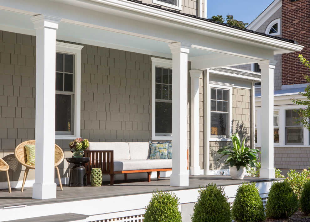 Small elegant mixed material railing porch photo in New York with decking and a roof extension