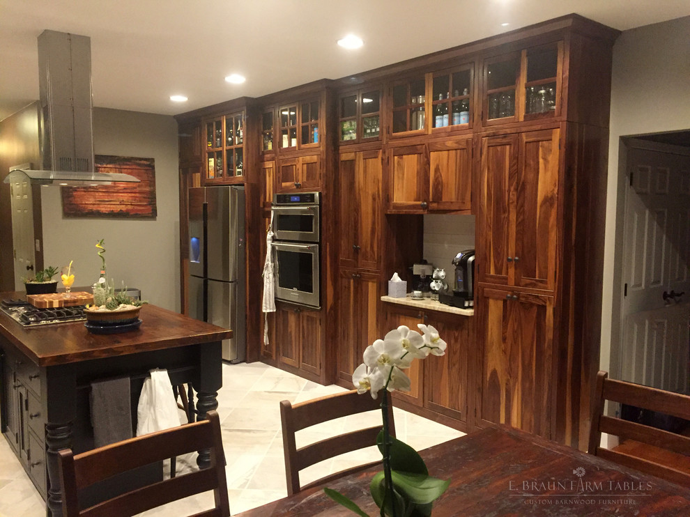 Transitional kitchen in Other with shaker cabinets and with island.