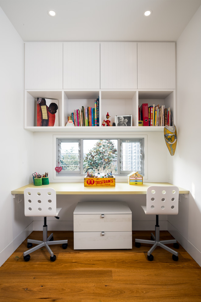 Design ideas for a contemporary gender-neutral kids' study room in Sydney with medium hardwood floors.