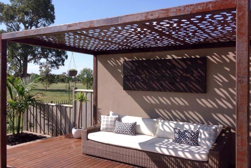 Large eclectic backyard patio in Melbourne with a gazebo/cabana.