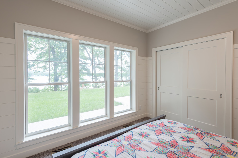 Photo of a mid-sized transitional master bedroom in Minneapolis with grey walls, carpet, no fireplace and grey floor.