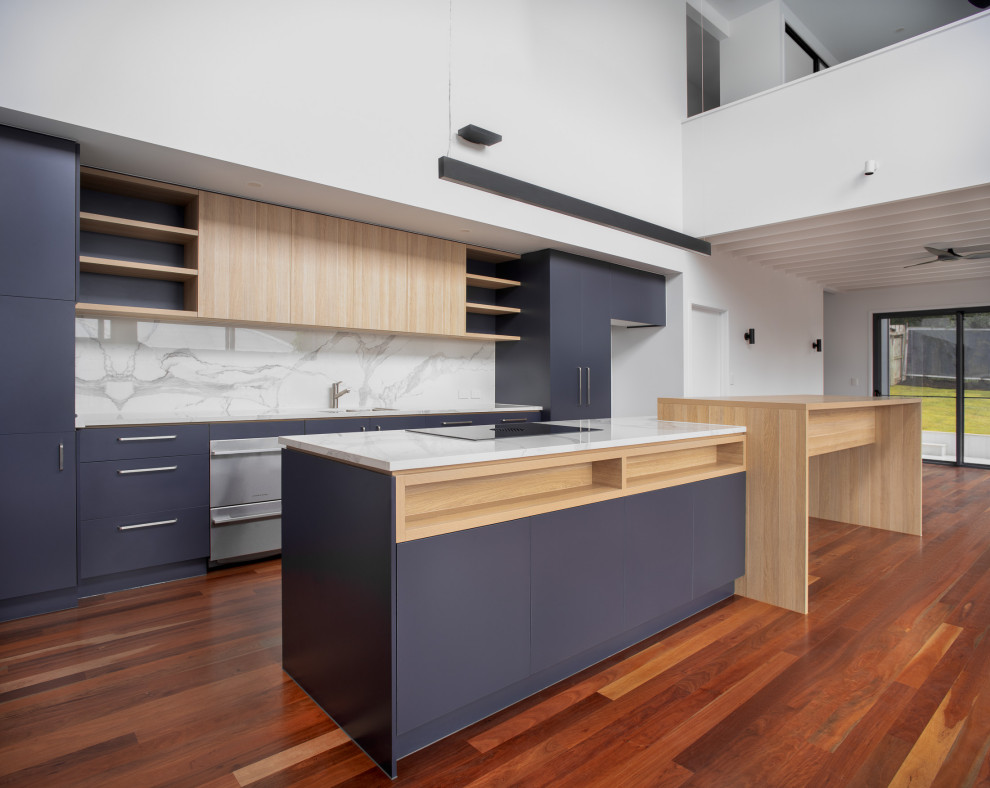 Photo of a large contemporary galley eat-in kitchen in Brisbane with an undermount sink, blue cabinets, tile benchtops, ceramic splashback, stainless steel appliances, medium hardwood floors and with island.