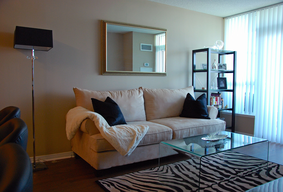 Inspiration for a small contemporary formal enclosed living room in Toronto with beige walls and dark hardwood floors.