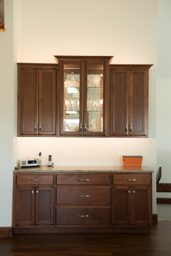 Example of a large transitional l-shaped medium tone wood floor open concept kitchen design with an undermount sink, flat-panel cabinets, medium tone wood cabinets, quartz countertops, white backsplash, ceramic backsplash, stainless steel appliances, an island and multicolored countertops